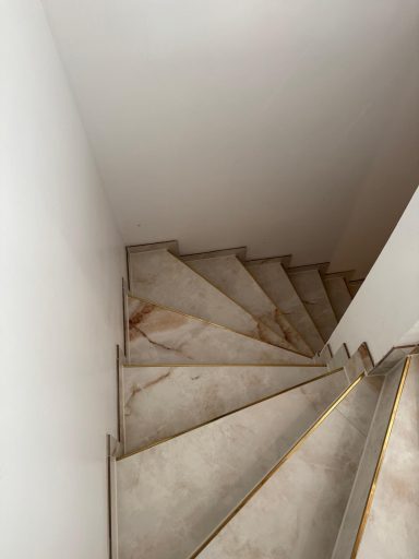Hochglanz-Fliesen auf moderner Treppe mit goldfarbenen Akzenten-stilvoll verlegt von Fliesenleger Muriqi