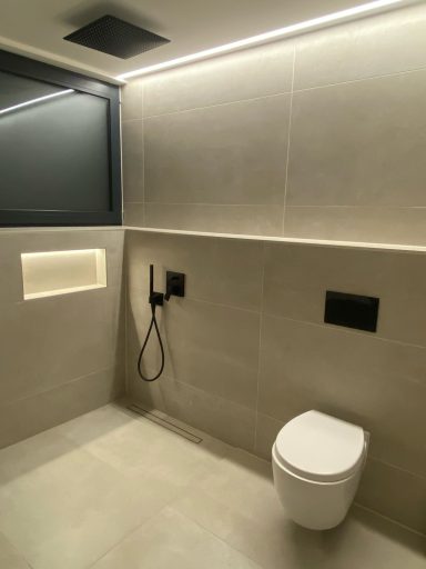 Modernes Bad mit LED-Nische, matten 120x60 Fliesen und schwarzen Armaturen